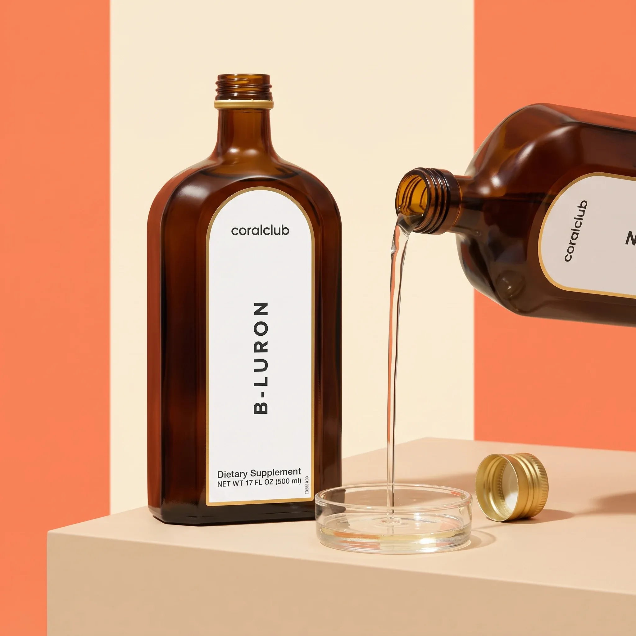 B-Luron liquid being poured from the opened amber bottle into a small glass dish.