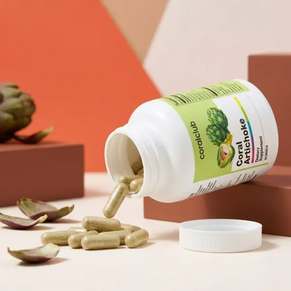 Coral Artichoke dietary supplement bottle with capsules spilling out on a minimalist background.
