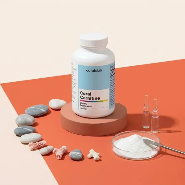 Coral Carnitine dietary supplement bottle with white powder and decorative stones.