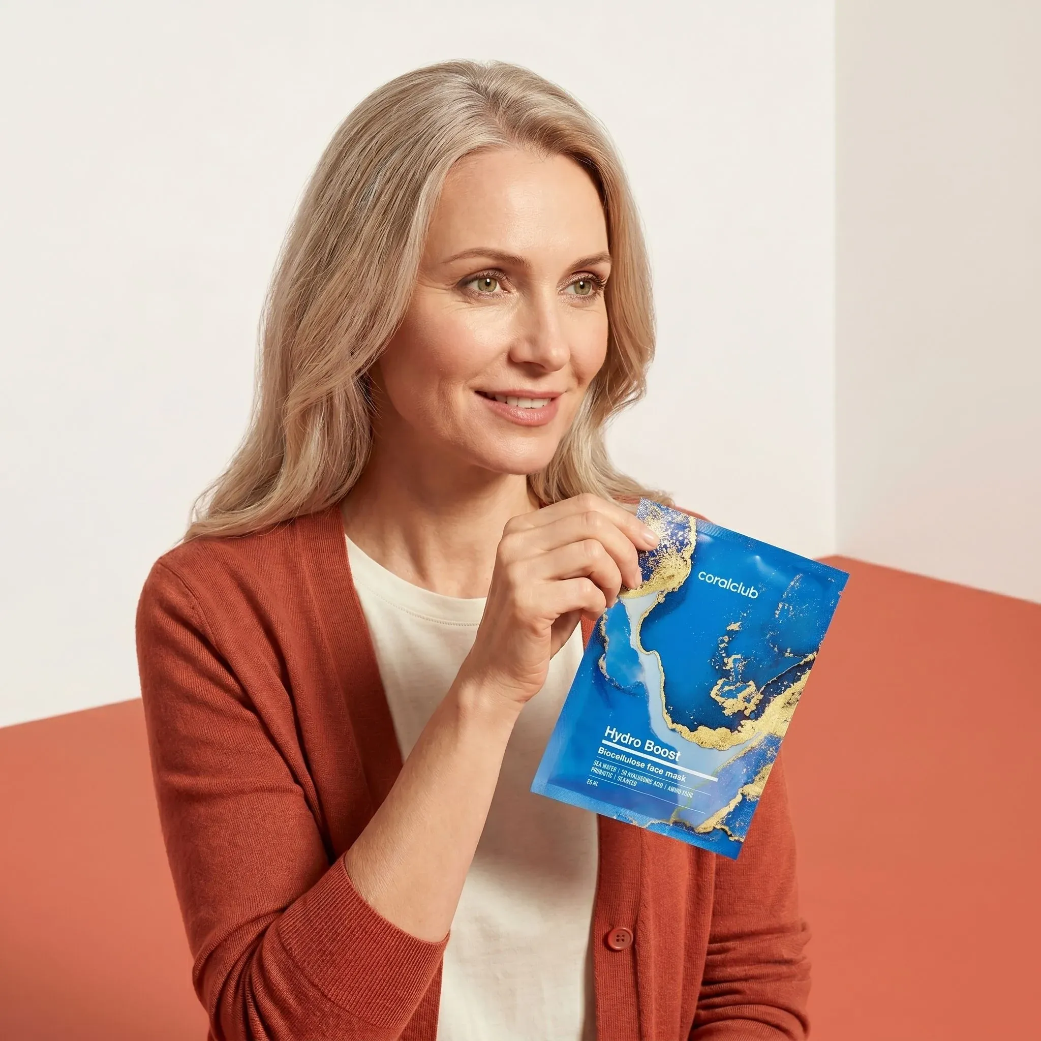 Hydro Boost Biocellulose Facial Mask lifestyle image featuring a woman holding the mask.