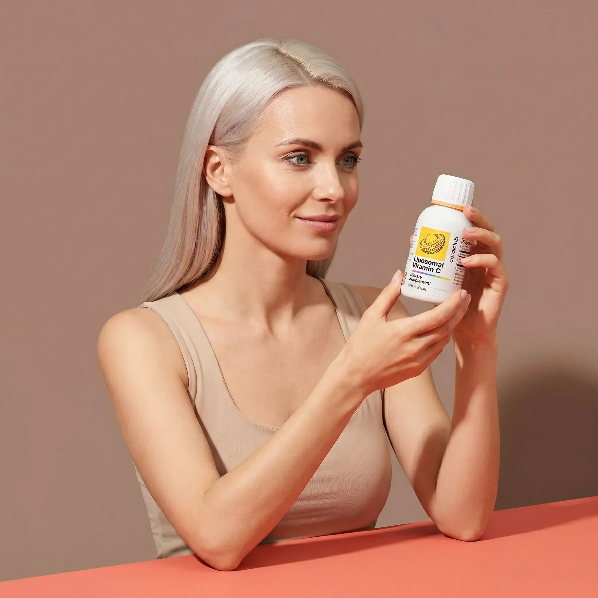Woman holding Liposomal Vitamin C bottle in a lifestyle setting.