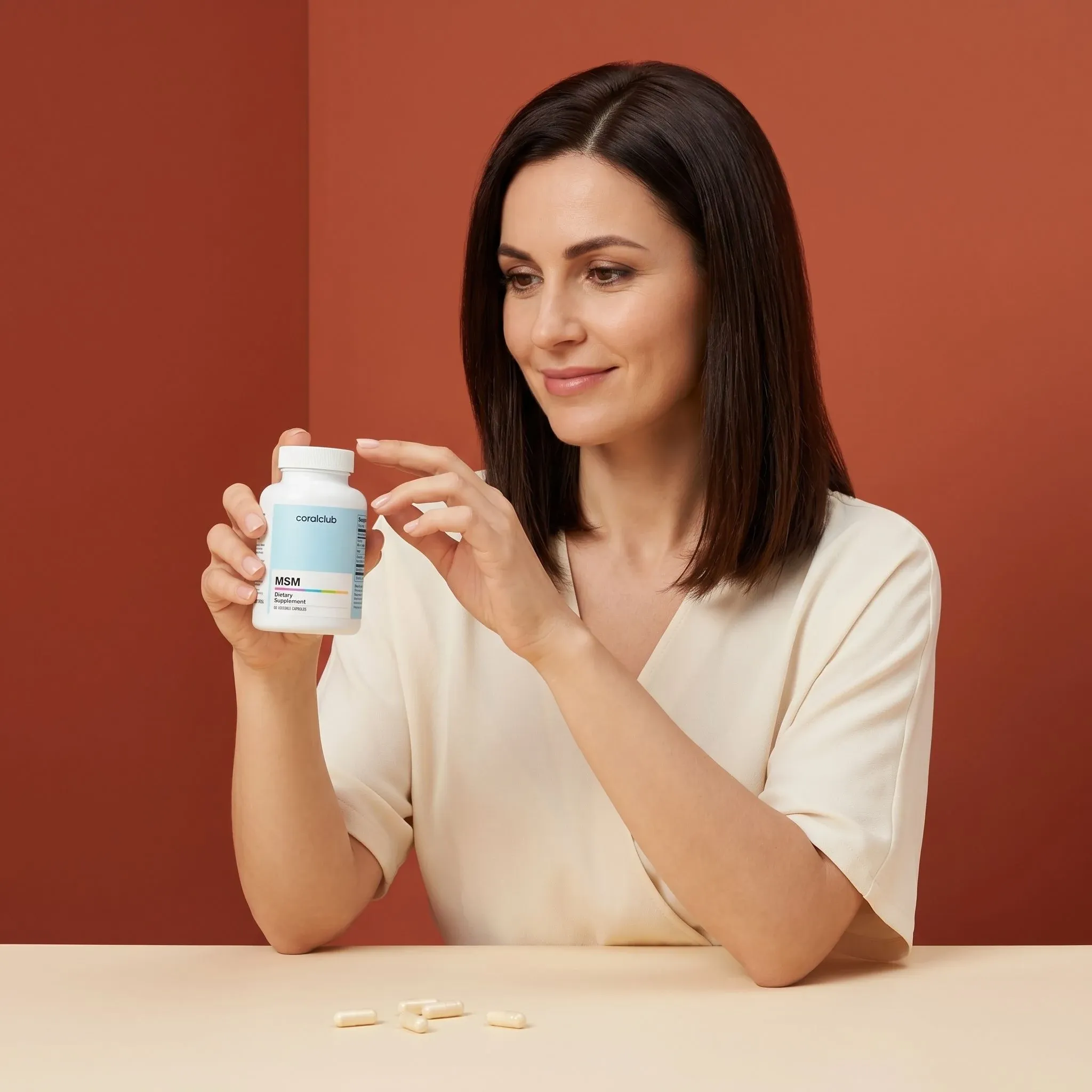 Woman examining a bottle of MSM supplements in a lifestyle setting with soft, warm tones.