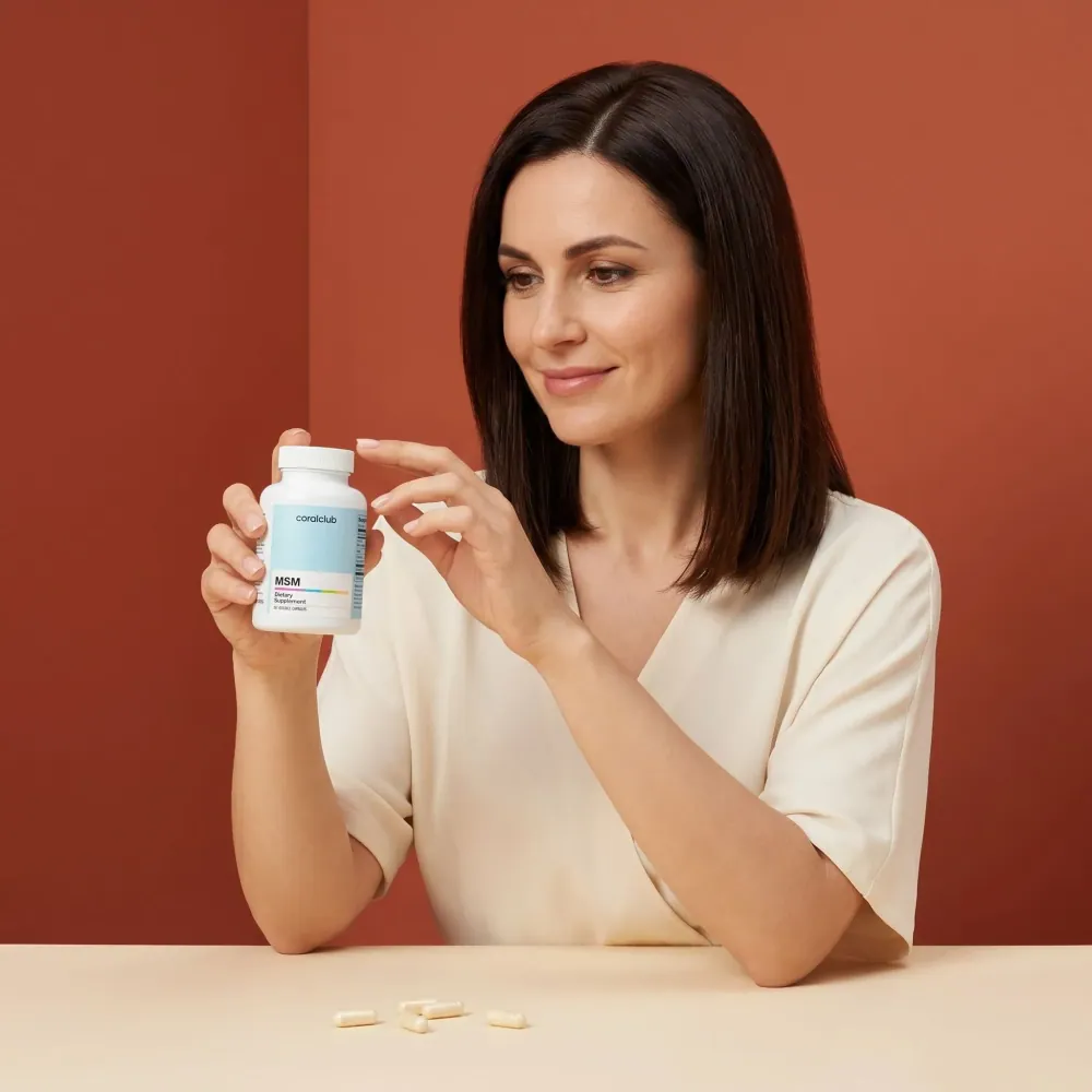 Woman examining a bottle of MSM supplements in a lifestyle setting with soft, warm tones.