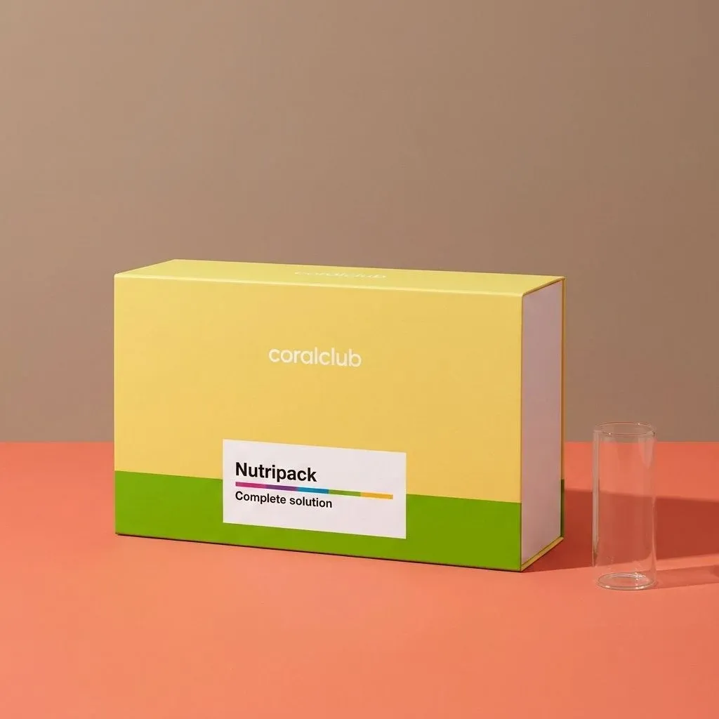 Nutripack packshot featuring a yellow box with a clear tube on a coral and beige background.