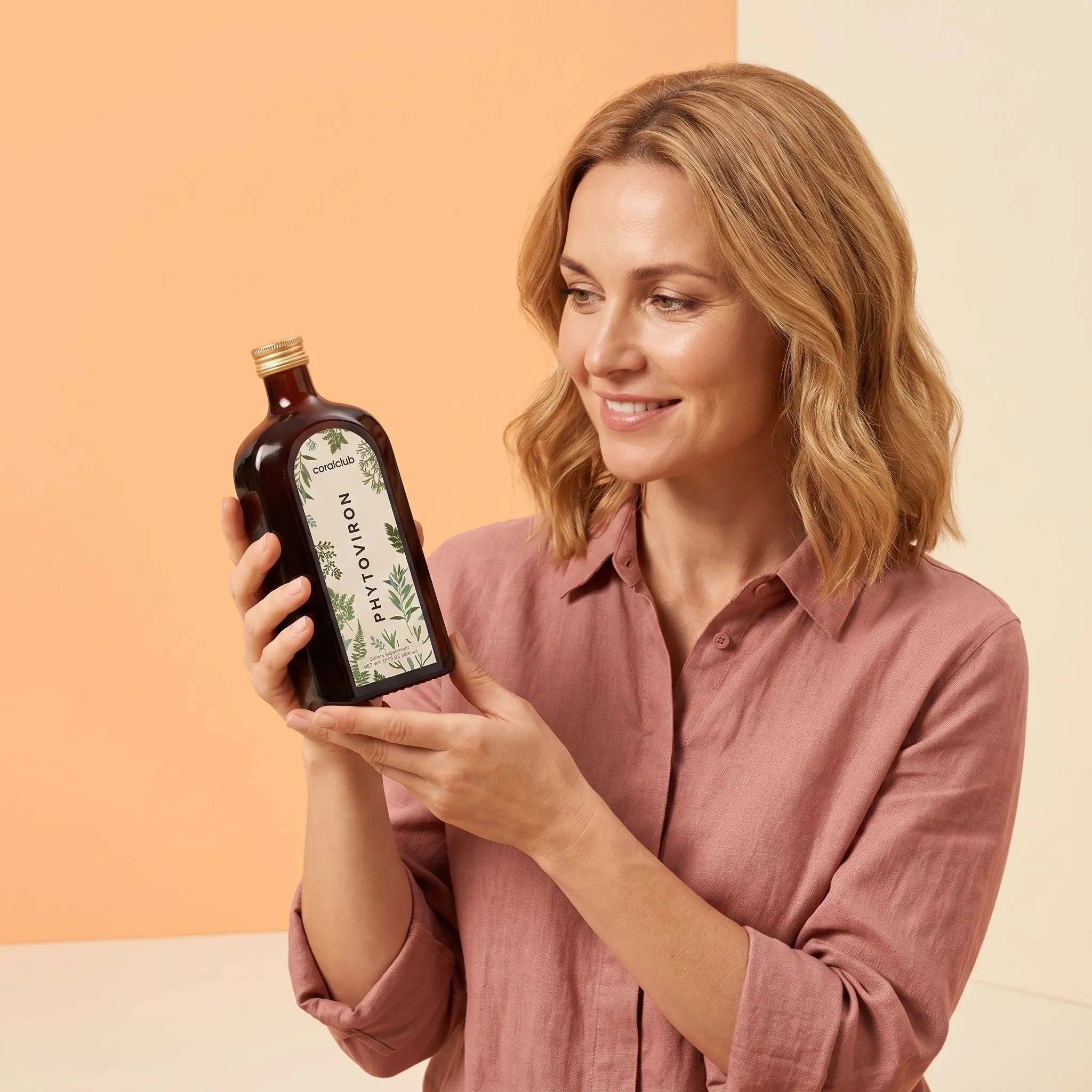 Woman holding a bottle of Phytoviron against a soft pastel backdrop.