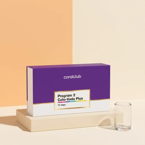 Colo-Vada Plus program box on a cream plinth beside an empty drinking glass.