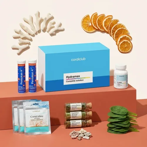 HydraMax ingredient collection with supplements, coral, dried orange slices, and fresh spinach.
