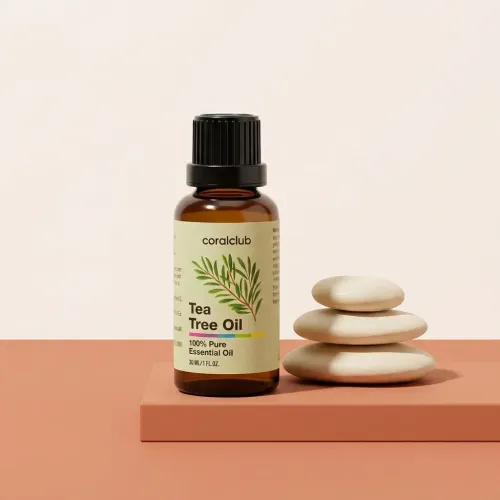 Tea Tree Oil packshot with essential oil bottle and stacked stones on a minimalist background.