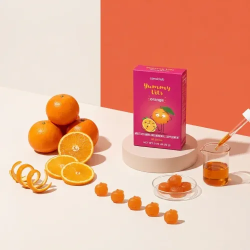 Yummy Vits Orange multivitamin gummies with fresh oranges and a dropper on a pastel background.