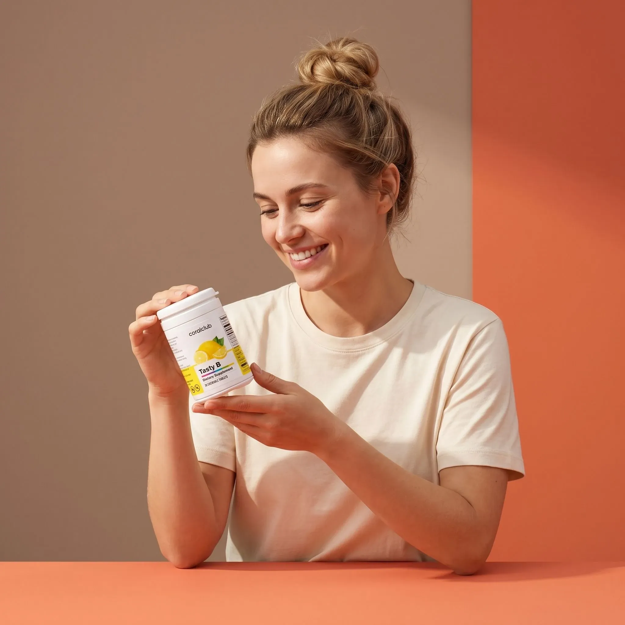 Tasty B lifestyle shot with a woman smiling while holding the product container.