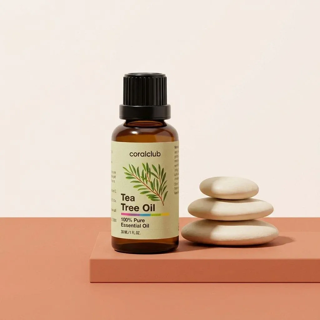 Tea Tree Oil packshot with essential oil bottle and stacked stones on a minimalist background.